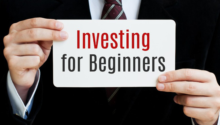 professional white male hands holding Investing for beginners sign